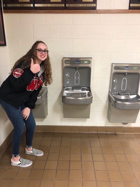Abby Malone poses with her favorite water fountain