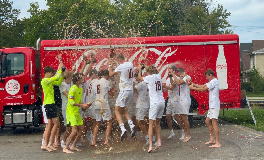 Lincoln-Way Central Varsity Boys Soccer team celebrates Body Armor tournament Victory by spraying Coca-Cola all over eachother