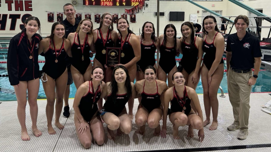 The girls Swim team poses with their medals.