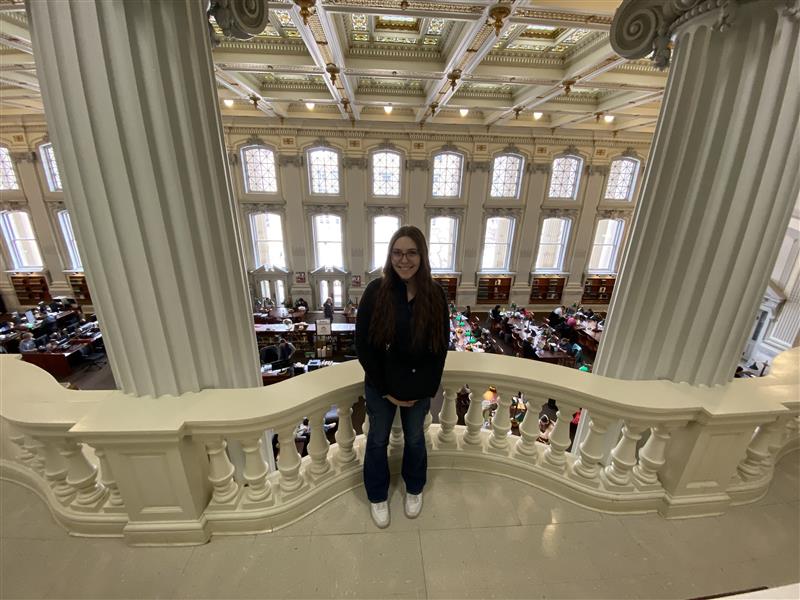 Kathryn Clark poses amidst studying students at the University of Wisconsin Madison. 