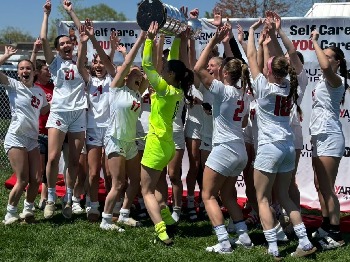 The girls varsity soccer team celebrate their win in the Body Armour Championship game!